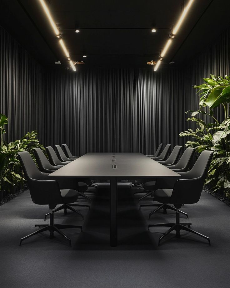 A boardroom table and chairs in a high-end dark kitted out office.