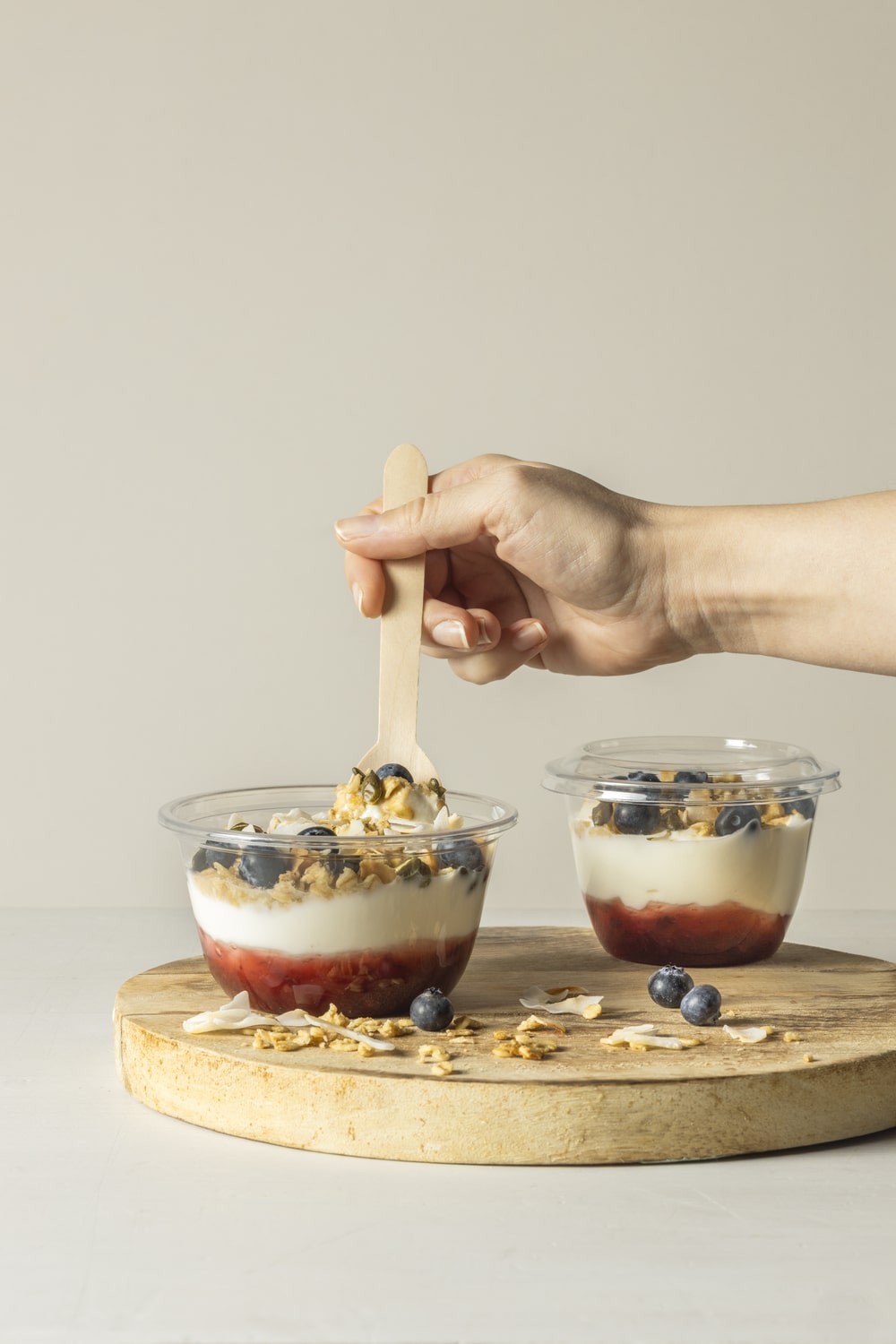 Yucca Packaging's dessert cups and lids on display with layered yoghurt puddings and topped with blueberries.