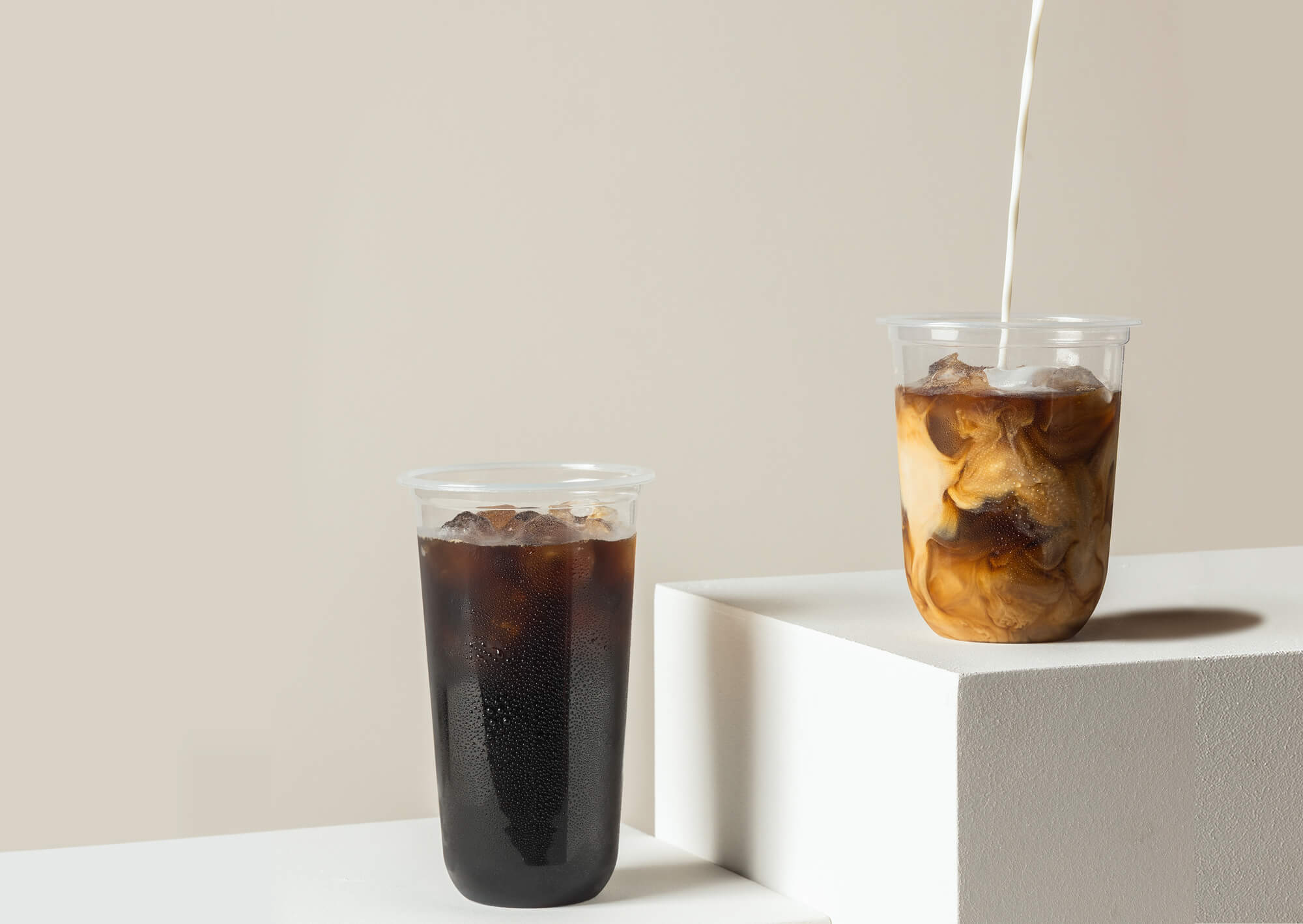 Pedestal display of innovative Yucca Packaging cups filled with iced coffee.