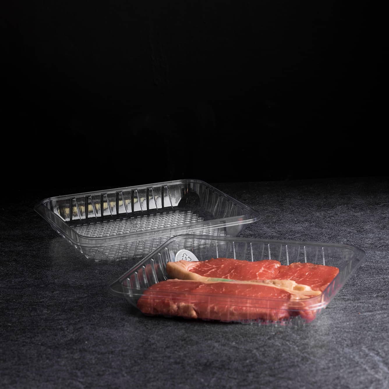 Yucca Packaging purge-lock open cell tray packed with thinly sliced steaks.